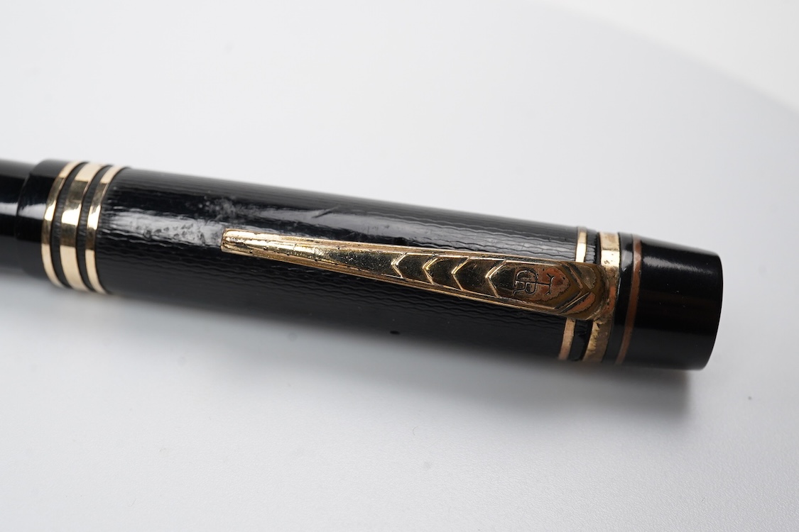 A De la Rue Onoto piston fill fountain pen in large size with ornate cap banding and fitted with DLR Onoto No.5 14ct. nib